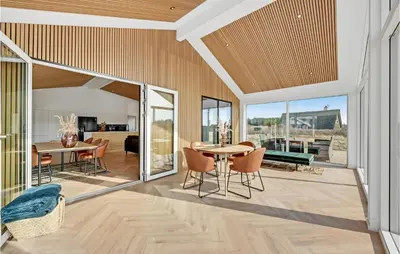 an open living room with a table and chairs at Awesome Home In Harboøre With Kitchen in Harboør