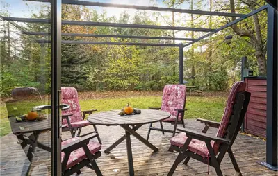 a patio with a table and chairs on a deck at Gorgeous Home In Roslev With Wifi in Roslev
