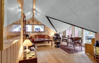 a living room with aamed ceilings and a table and chairs at Gorgeous Home In Roslev With Wifi in Roslev