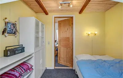 a small room with a bed and a door at Gorgeous Home In Lemvig With Wifi in Lemvig