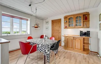 a kitchen and dining room with a table and chairs at Gorgeous Home In Lemvig With Wifi in Lemvig