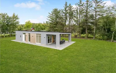 a modular home with a large yard with grass at Awesome Home In Nibe With Kitchen in Nibe