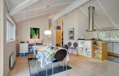 a dining room with a table and chairs in a room at Lovely Home In Bedsted Thy With Sauna in Bedsted Thy