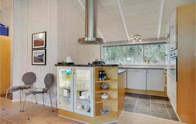 a kitchen with a counter with a glass cabinet at Lovely Home In Bedsted Thy With Sauna in Bedsted Thy
