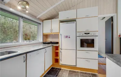 a kitchen with white cabinets and a refrigerator at Lovely Home In Bedsted Thy With Sauna in Bedsted Thy