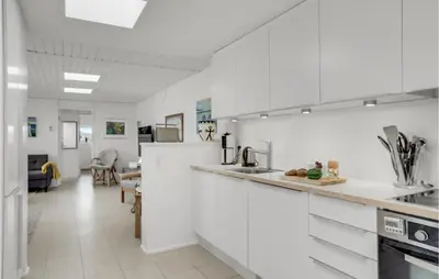 a kitchen with white cabinets and a counter top at Awesome Home In Pandrup With Wifi in Pandrup