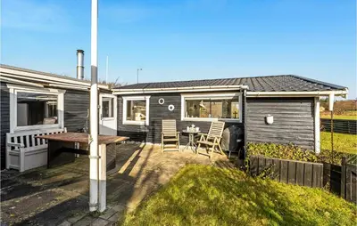 a tiny house with a table and chairs on a patio at 1 Bedroom Lovely Home In Løgstør in Løgstør