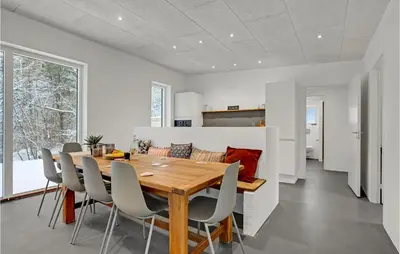a kitchen and dining room with a wooden table and chairs at Beautiful Home In Vestervig With Wifi in Vestervig