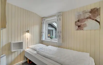 a bedroom with a bed and a window at Amazing Home In Thisted With Sauna in Thisted