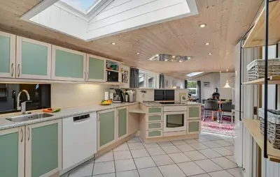 a kitchen with green cabinets and a skylight at Amazing Home In Thisted With Sauna in Thisted