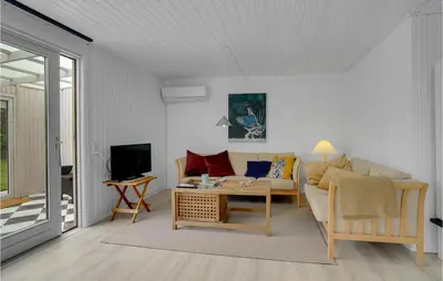 a living room with a couch and a table at Stunning Home In Vemb With Wifi in Vemb