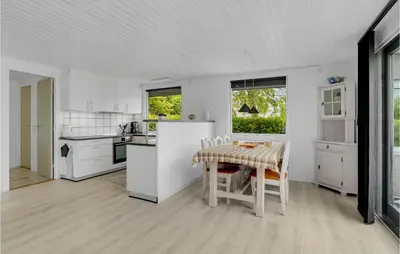 a kitchen with white appliances and a table and chairs at Stunning Home In Vemb With Wifi in Vemb