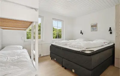 two beds in a bedroom with white walls and a window at 3 Bedroom Lovely Home In Hurup Thy in Sønder Ydby