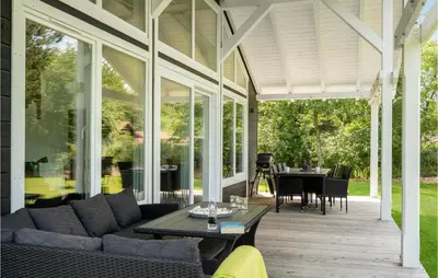 a screened in porch with a couch and a table at Gorgeous Home In Thyholm With Wifi in Thyholm