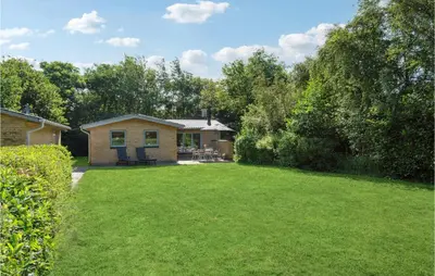 a small house in a yard with a green lawn at 3 Bedroom Lovely Home In Hurup Thy in Sønder Ydby