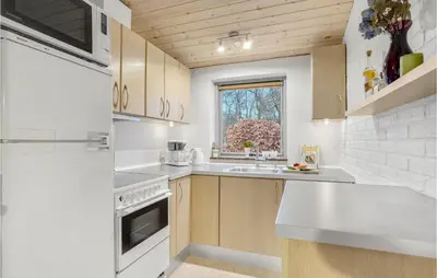 a kitchen with white appliances and a window at 3 Bedroom Lovely Home In Hurup Thy in Sønder Ydby