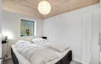 a bedroom with white walls and a large bed at 3 Bedroom Lovely Home In Hurup Thy in Sønder Ydby