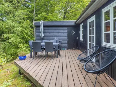 a wooden deck with a table and chairs on it at 4 person holiday home in Aars-By Traum in Års