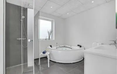 a white bathroom with a tub and a shower at Amazing Home In Harboøre With 4 Bedrooms, Sauna & Wifi in Harboør