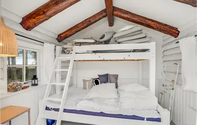 a bunk bed in a room with a ladder at 3 Bedroom Cozy Home In Hurup Thy in Sønder Ydby