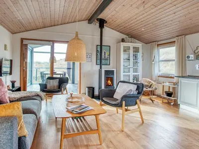a living room with a couch and a table at 6 person holiday home in Pandrup-By Traum in Pandrup