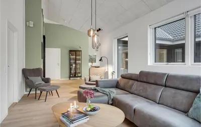 a living room with a couch and a table at Gorgeous Home In Blokhus With Jacuzzi in Blokhus