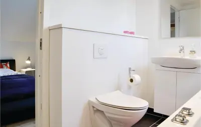 a white bathroom with a toilet and a sink at Cozy Home In Lemvig With Wifi in Lemvig