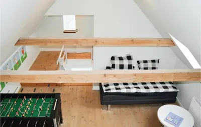 a living room with a table and a couch at Cozy Home In Lemvig With Wifi in Lemvig