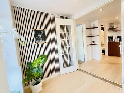 a living room with a striped wall at aday - 3 bedrooms luxurious apartment in Svenstrup in Svenstrup