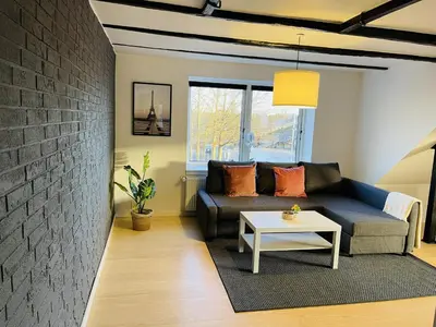 a living room with a couch and a table at aday - 3 bedrooms luxurious apartment in Svenstrup in Svenstrup