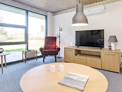 a living room with a tv and a table at 6 person holiday home in Vesløs-By Traum in Øsløs