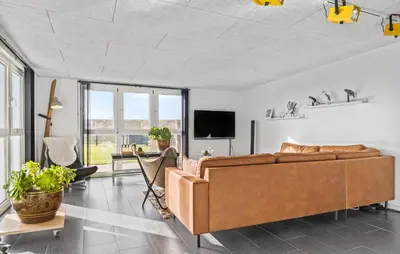 a living room with a couch and a table at 3 Bedroom Nice Home In Thyborøn in Thyborøn