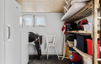 a tiny house with a ladder and a room with a shelf at 3 Bedroom Nice Home In Thyborøn in Thyborøn