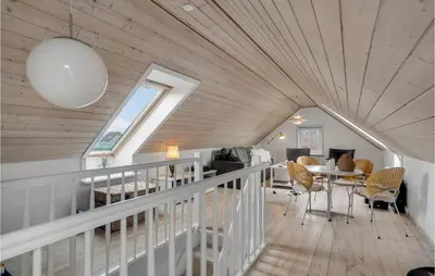 a room with a wooden ceiling with a table and chairs at 3 Bedroom Gorgeous Home In Vestervig in Vestervig