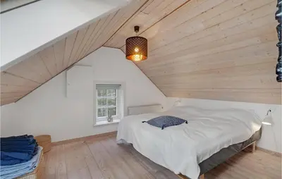 a bedroom with a bed and a wooden ceiling at 3 Bedroom Gorgeous Home In Vestervig in Vestervig