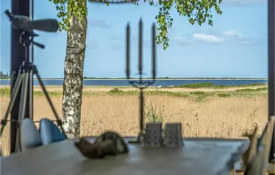 a table with a view of a beach with a camera at 4 Bedroom Gorgeous Home In Fur in Furland