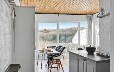 a kitchen with a table and chairs and a window at Gorgeous Apartment In Vestervig in Vestervig