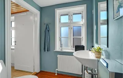 a bathroom with a white sink and a window at 5 Bedroom Awesome Home In Erslev in Erslev