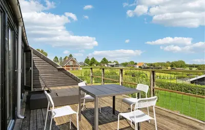 a patio with a table and chairs on a deck at Nice Home In Øster Assels With Wifi in Øster Assels