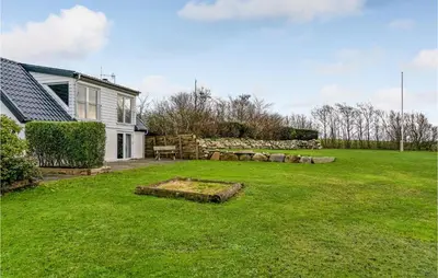 a yard with a house and a garden with a bench at Nice Home In Erslev With Wifi in Erslev