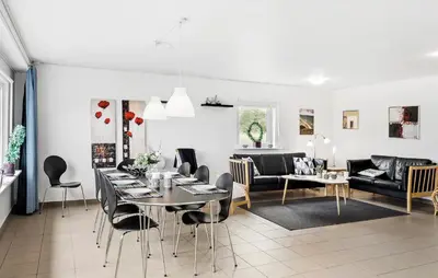 a dining room and living room with a table and chairs at 3 Bedroom Amazing Home In Vesløs in Øsløs