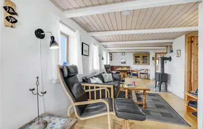 a living room with a couch and a table at Gorgeous Home In Thyholm With Kitchen in Thyholm