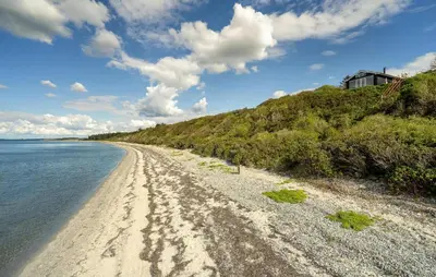 a view of a sandy beach next to the water at 2 Bedroom Nice Home In Roslev in Roslev