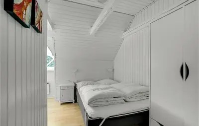 a bedroom with a bed in a white room at Amazing Home In Vestervig With Sauna in Vestervig