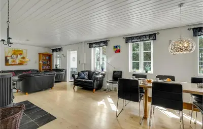 a living room with a table and chairs at Amazing Home In Vestervig With Sauna in Vestervig