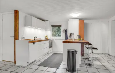a kitchen with white cabinets and a table at Pet Friendly Home In Spøttrup With Wifi in Spottrup