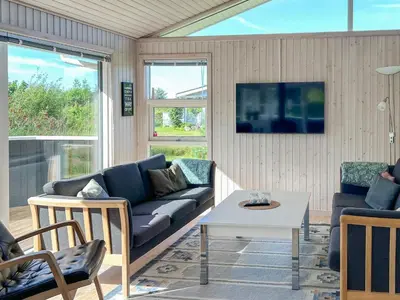 a living room with a couch and a table at 7 person holiday home in Løgstør-By Traum in Løgsted