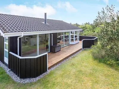 a modern house with a deck and a yard at 7 person holiday home in Løgstør-By Traum in Løgsted
