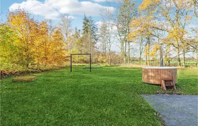 a park with a goal and a bench in the grass at Stunning Home In Nibe With Kitchen in Store Ajstrup