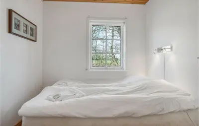 a bed in a white room with a window at Stunning Home In Nibe With Kitchen in Store Ajstrup